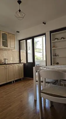 a kitchen and dining room with a table and chairs at Lena's Place Near City Center in Bar