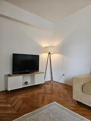 a living room with a flat screen tv on a white wall at Lena's Place Near City Center in Bar