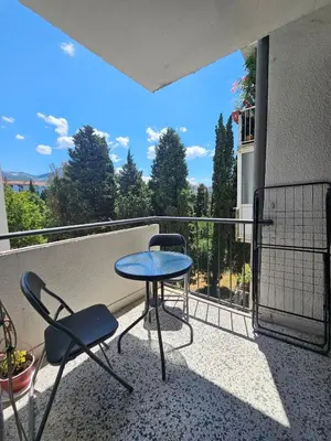 a patio with a table and chairs on a balcony at Lena's Place Near City Center in Bar