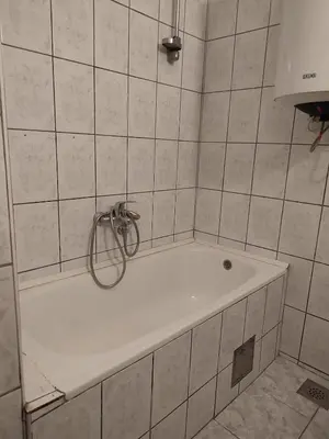 a bath tub in a tiled bathroom with a shower at Lena's Place Near City Center in Bar
