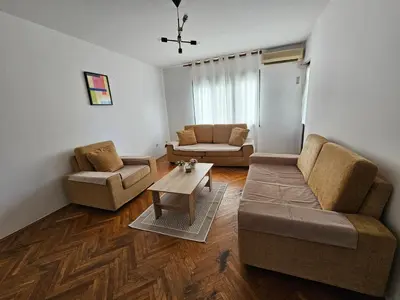 a living room with two couches and a coffee table at Lena's Place Near City Center in Bar