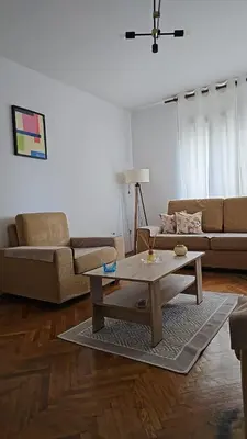 a living room with a couch and a coffee table at Lena's Place Near City Center in Bar