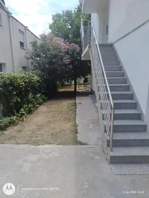 a set of stairs next to a building at Apartman V,P in Sutomore