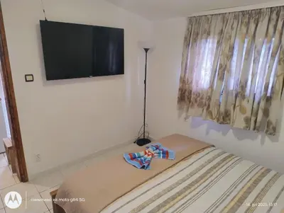 a bedroom with a bed and a flat screen tv at Apartman V,P in Sutomore