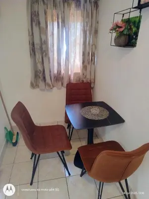 a dining room with a table and chairs at Apartman V,P in Sutomore