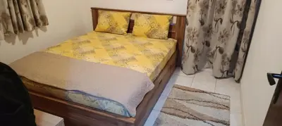 a bedroom with a bed with a yellow comforter at Apartman V,P in Sutomore