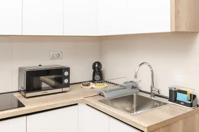 a kitchen with a microwave and a sink at Autentica Apart in Cetinje