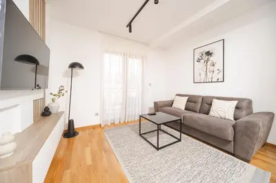 a living room with a couch and a table at Autentica Apart in Cetinje