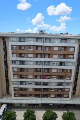 a large apartment building with a sky in the background at Apartment 82 Central Point in Podgorica