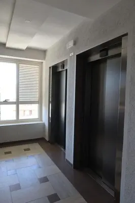 an empty room with black doors and a window at Apartment 82 Central Point in Podgorica