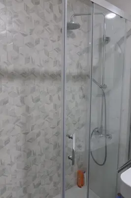 a bathroom with a shower with a glass door at Apartment 82 Central Point in Podgorica