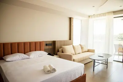 a hotel room with a bed and a couch at Cervino in Ulcinj