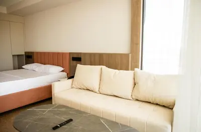 a living room with a couch and a bed at Cervino in Ulcinj