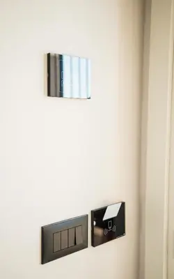 a wall mounted tv in a bathroom with a mirror at Cervino in Ulcinj