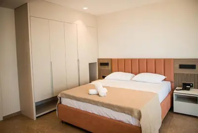 a bedroom with a bed with two towels on it at Cervino in Ulcinj