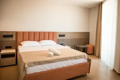 a bedroom with a bed with two towels on it at Cervino in Ulcinj