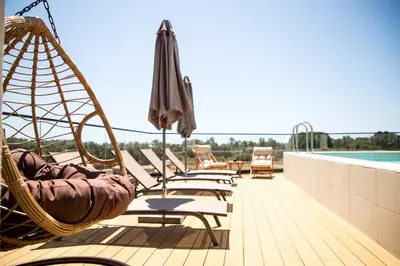 a row of chairs and umbrellas on a deck at Cervino in Ulcinj