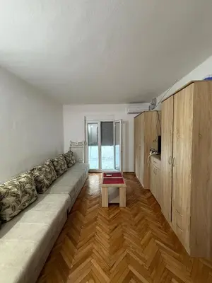 a living room with a long couch and a table at Ivan's Apartment in Budva in Budva