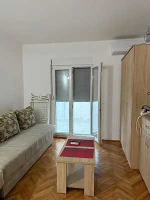 a living room with a couch and a coffee table at Ivan's Apartment in Budva in Budva