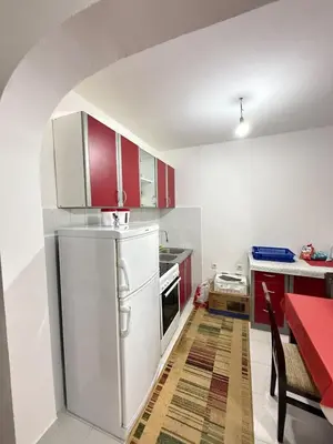 a kitchen with red cabinets and a white refrigerator at Ivan's Apartment in Budva in Budva