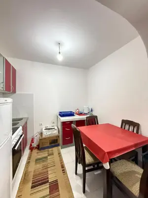 a kitchen with a red table and chairs in a room at Ivan's Apartment in Budva in Budva
