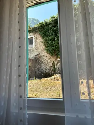 an open window with a view of a yard at Deaf Valley Apartment 1 in Reljići