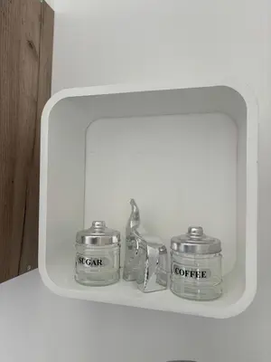 two metal containers sitting on a shelf in a mirror at Deaf Valley Apartment 1 in Reljići