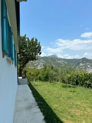 a sidewalk next to a building with mountains in the background at Deaf Valley Apartment 1 in Reljići