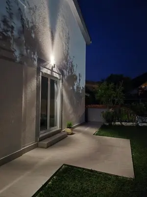 a night view of a house with a patio at Hayal Apartment in Bar