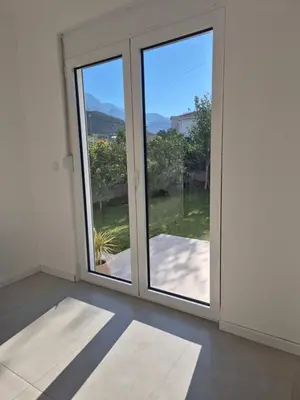 an empty room with a sliding glass door at Hayal Apartment in Bar