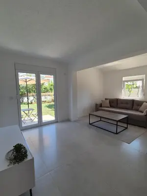 a living room with a couch and a table at Hayal Apartment in Bar