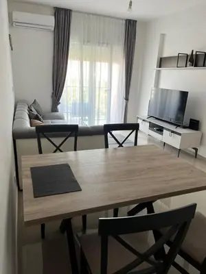 a living room with a table and a couch at Amber Sky Apartments in Bjeliši