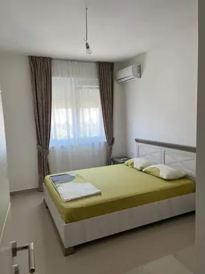 a bedroom with a bed and a window at Amber Sky Apartments in Bjeliši