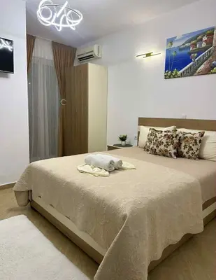 a bedroom with a bed with a bike on the wall at Villa Doda - Donji Stoj - Ulcinj in Ulcinj