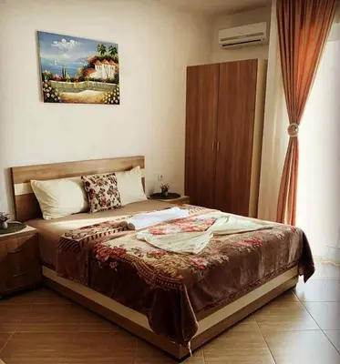 a bedroom with a bed and a painting on the wall at Villa Doda - Donji Stoj - Ulcinj in Ulcinj