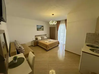a bedroom with a bed and a couch in a room at Villa Doda - Donji Stoj - Ulcinj in Ulcinj