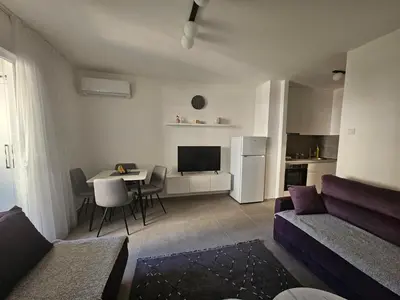 a living room with a couch and a table at Rozino Budva in Budva