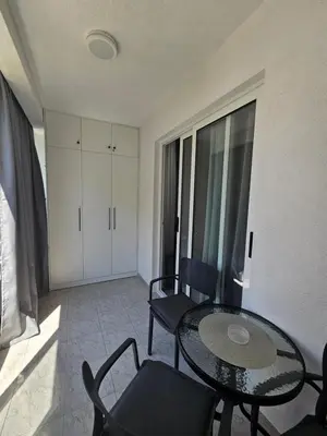 a living room with a glass table and chairs at Rozino Budva in Budva