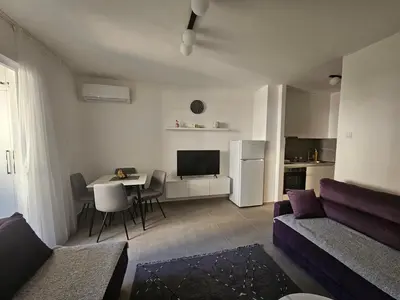 a living room with a couch and a table at Rozino Budva in Budva