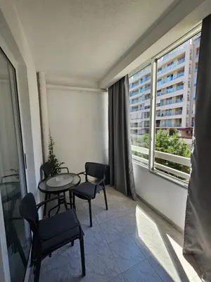 a room with a table and chairs and a large window at Rozino Budva in Budva