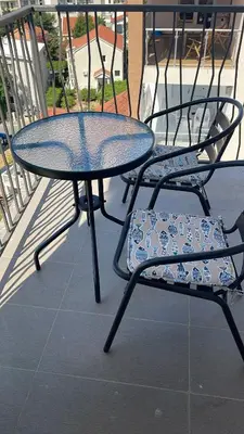 a table and two chairs sitting next to each other at MBv Budva in Budva