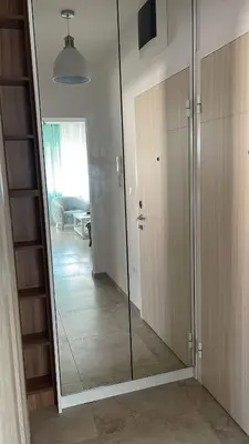a large mirror in a room with a hallway at MBv Budva in Budva