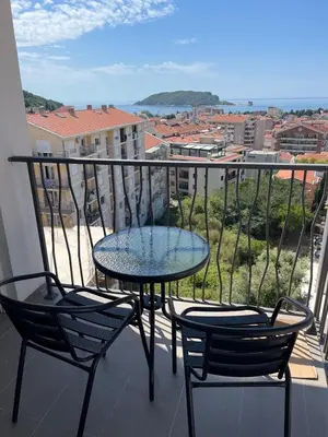 a table and two chairs on a balcony with a view at MBv Budva in Budva