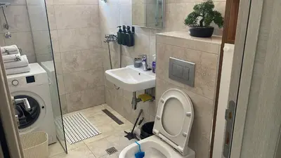 a bathroom with a toilet and a sink at MBv Budva in Budva