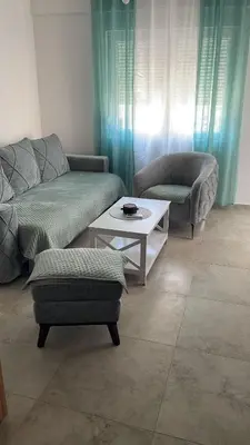 a living room with a couch and a table at MBv Budva in Budva
