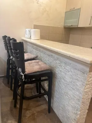 a bar with four chairs sitting at a counter at Apartman Martina 3 in Rafailovici