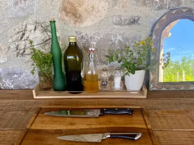 a wooden shelf with bottles and a knife on it at Rudinica Baseglamp in Gornji Brčeli
