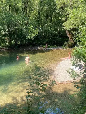 a group of people swimming in a river at Rudinica Baseglamp in Gornji Brčeli