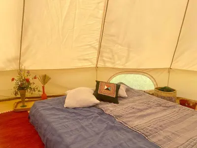 a bedroom with a bed in a tent at Rudinica Baseglamp in Gornji Brčeli