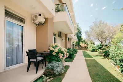 a patio with a table and chairs next to a building at Solea Apartments in Ulcinj
